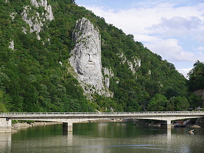 landscape photo of bridge and mountain range during daytime