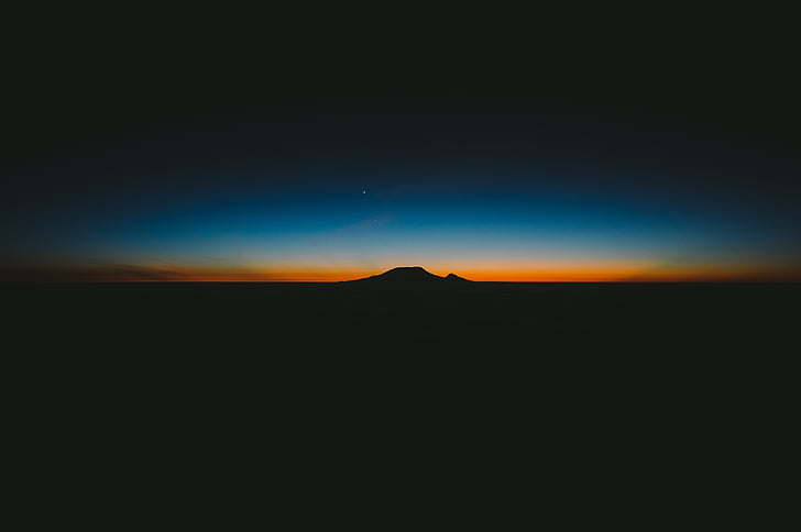silhouette of mountain during night