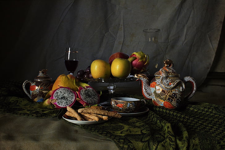 variety of fruits and teapot on brown textile