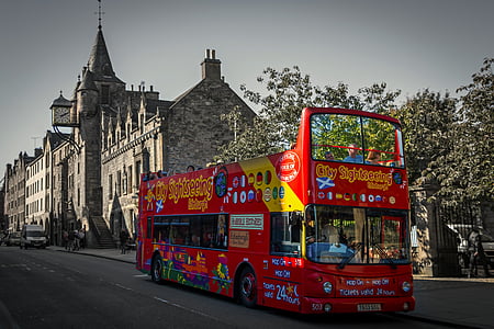 red and yellow double decker bus on concrete road