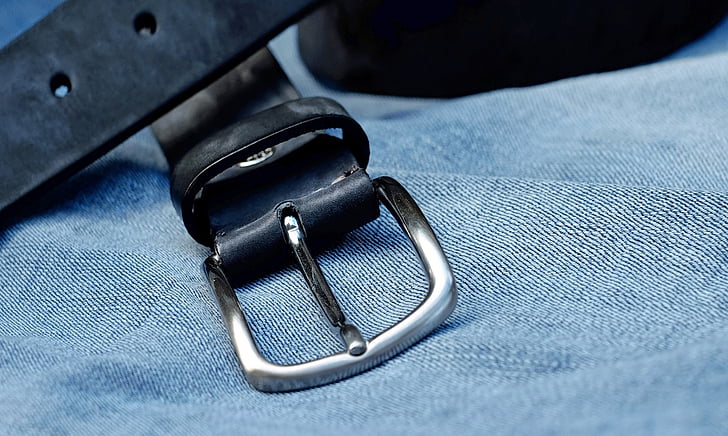 black leather belt on gray denim textile