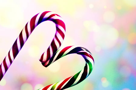 two candy canes forming heart bokeh photography