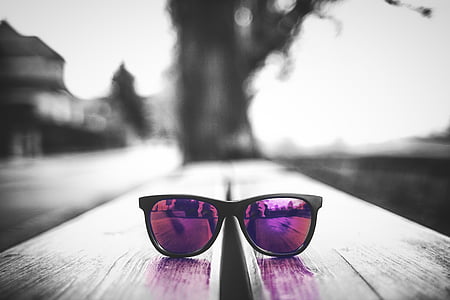 selective color photography of purple wayfarer-style sunglasses