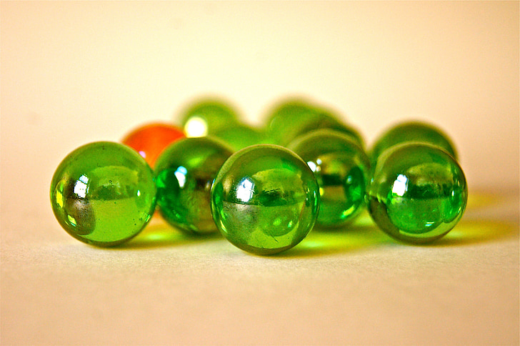 tilt shift lens photography of green marble balls
