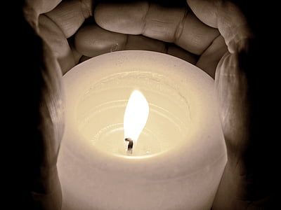 person holding pillar candle