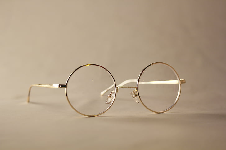 selective focus photo of gold framed hippie eyeglasses