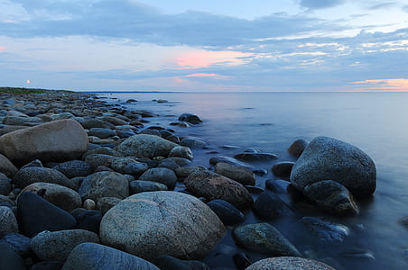time-lapse photography of rocky seashore during golden hour