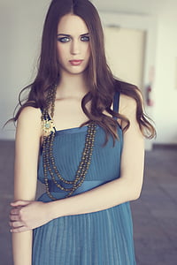 shallow focus photography of woman in blue sleeveless dress