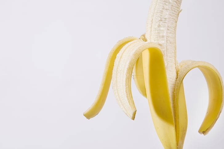 peeled banana with white background