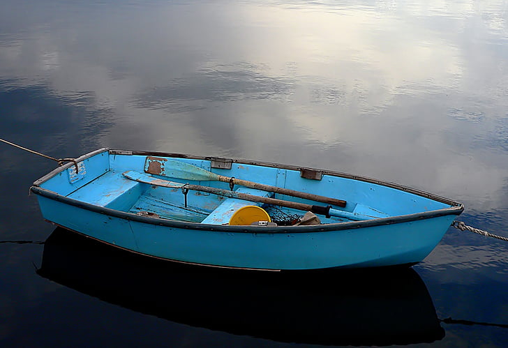 blue boat on waters
