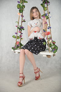 woman riding floral swing