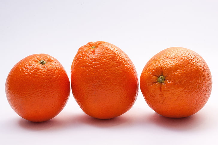 three oranges on white board
