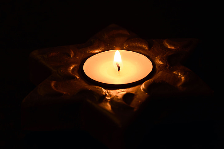 close up photo of lighted tealight candle