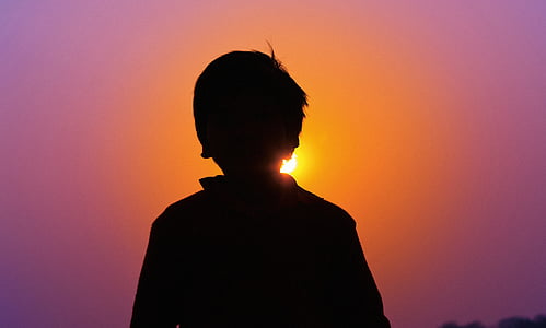 silhouette of boy during golden hour