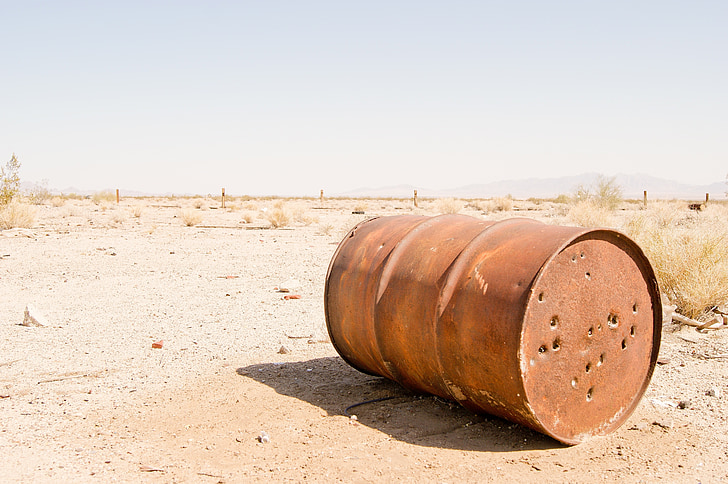 brown barrel on desert during daytime