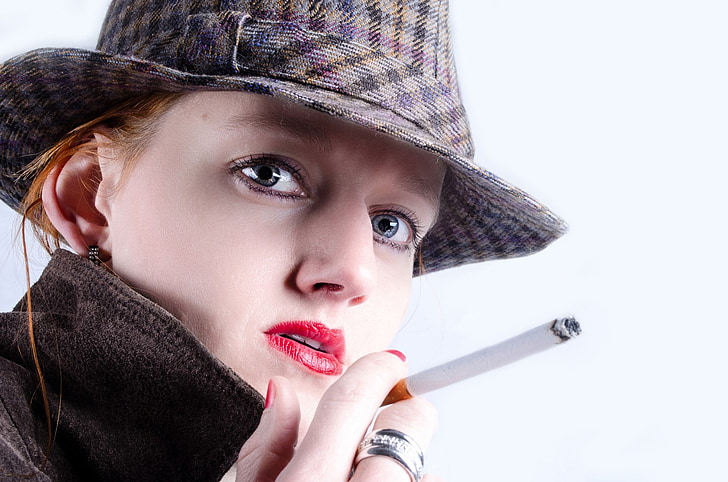 Royalty-Free photo: Woman holding cigarette stick | PickPik