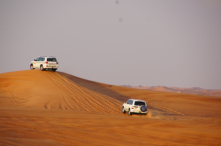 two white SUV on desert