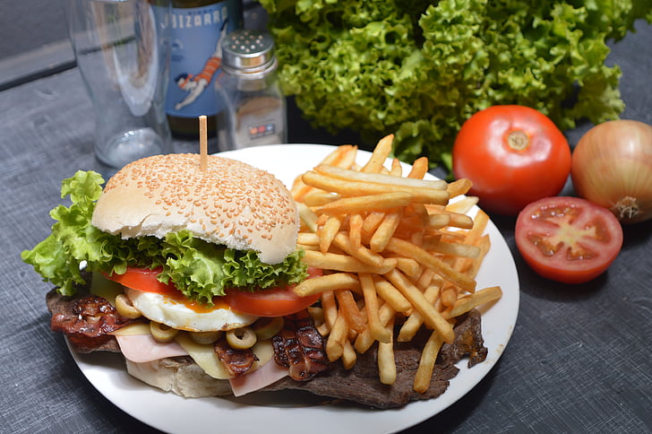 photo of burger with fries on white plate