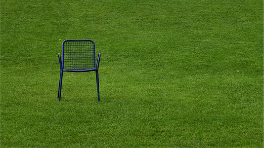 black metal armchair on grass field