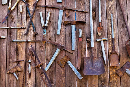 assorted gardening tools on brown surface