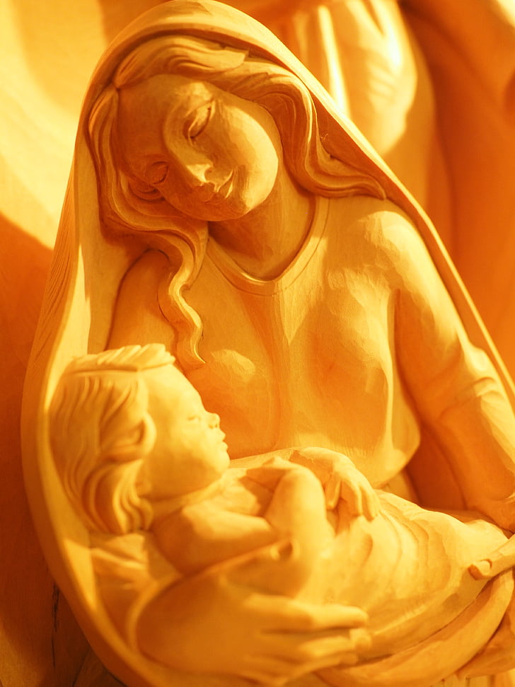 photo of woman holding child figurine