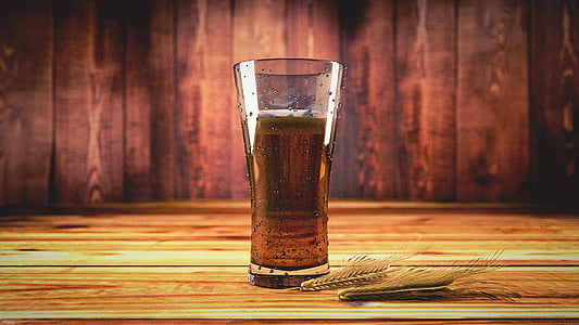 clear pilsner glass with brown liquid inside