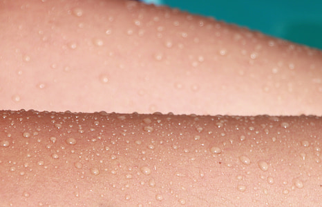 closeup photo of human skin with water dew