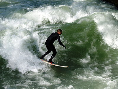 man surfboarding on sea