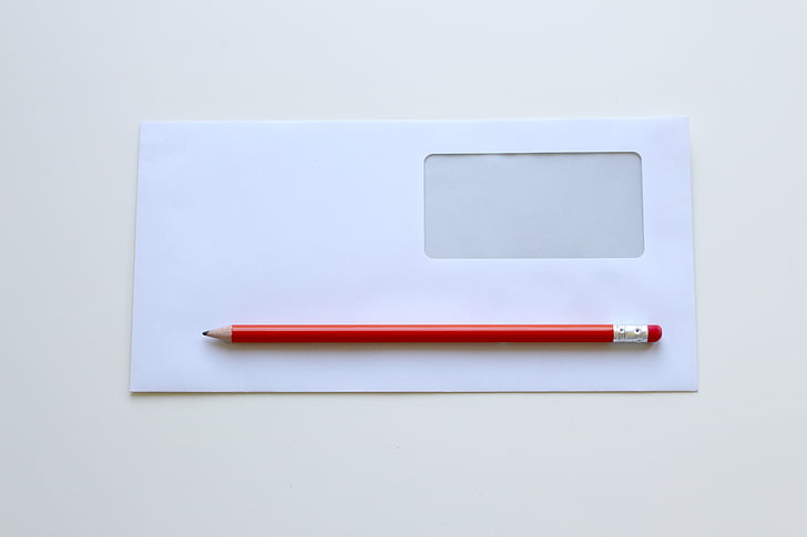 red pencil on white window envelope