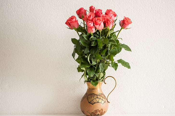pink rose arrangement on brown vase
