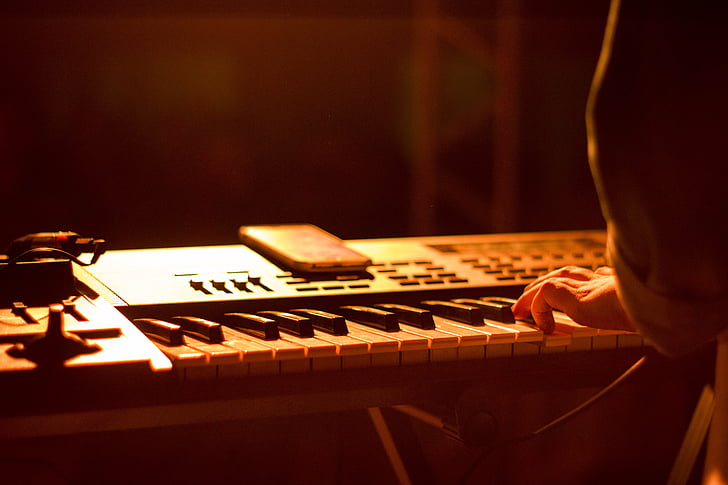 person holding electronic keyboard