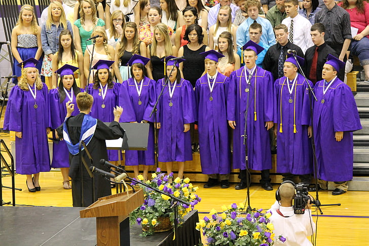 choir singing during graduation ceremony inside gymnasium