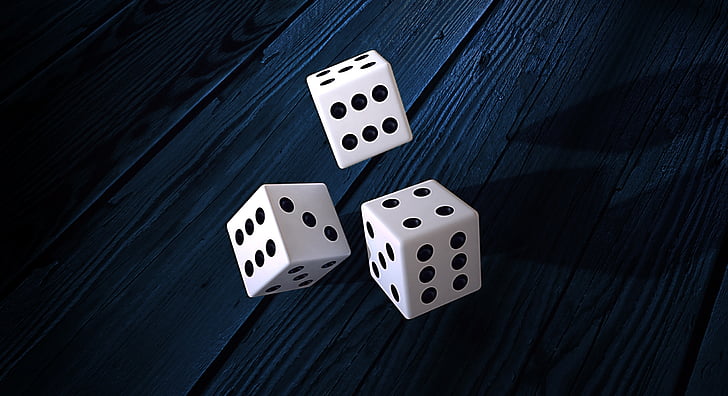 three dice on wooden tables