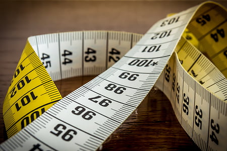 closeup photo of yellow and white measuring tape