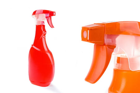 two red and orange plastic sprayers