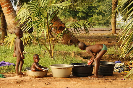 kids bathing near trees during daytime
