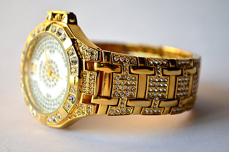 round gold-colored analog watch with gold-colored link bracelet
