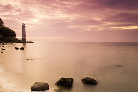 Royalty-Free photo: White lighthouse on body of water under white ...