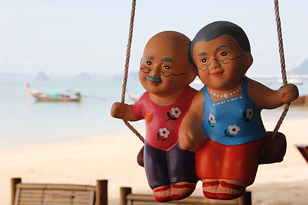 closeup photo of woman and man swing toy