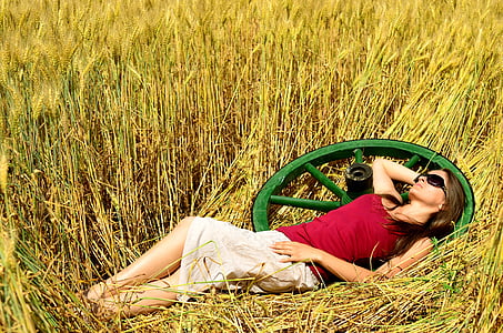 woman laying on a grass field