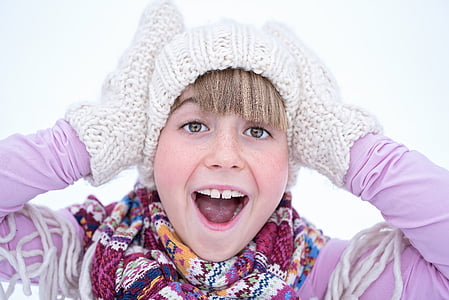 photo of girl wearing knitted mittens
