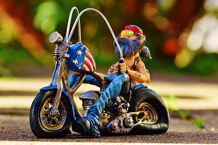 shallow focus photography of man on motorcycle figurine