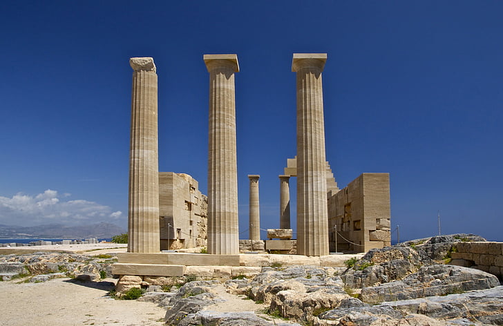 three columns with ruined structure