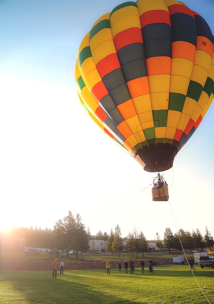 yellow and multicolored hot air balloon under blue sky
