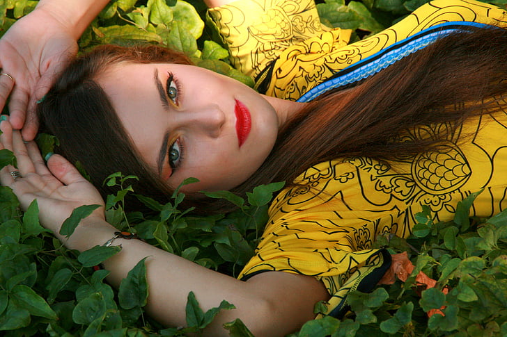 woman lying on green leaf plants