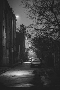 grayscale photography of car parked beside the street