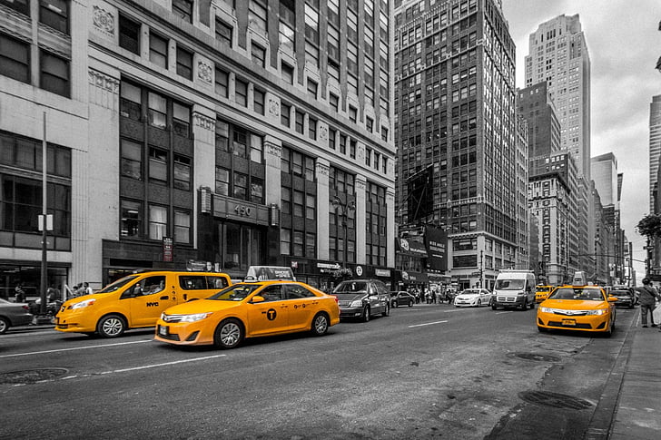 selective color photography of three orange taxis