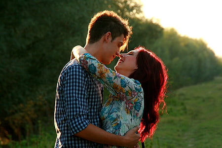 couple embracing each other near trees during daytime