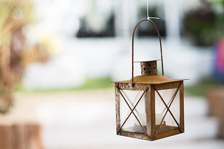 shallow focus photograph of brown candle lantern