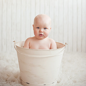 baby inside white pail